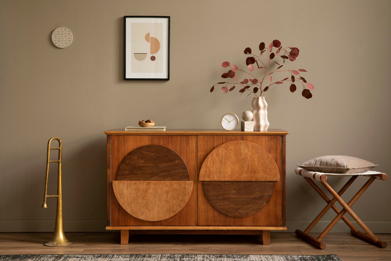 Stylish interior with design wooden commode, unique decorations, mock up poster frame and elegant personal accessories. Modern living room in classic house.